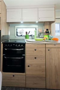 Lower kitchen storage consists of three drawers and cupboards.