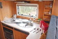 motorhome kitchen with tea sugar and coffee in the cupboards