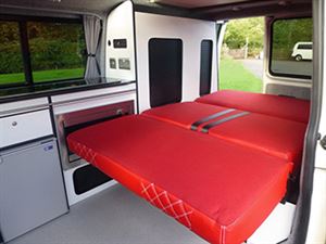 One of the conversions with bright red, fold down bed