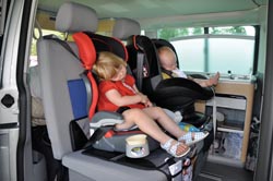 children in safe car seats in a motorhome